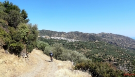 descenting with the mountain bike to Krevatas village. Agios Vasilios on the background