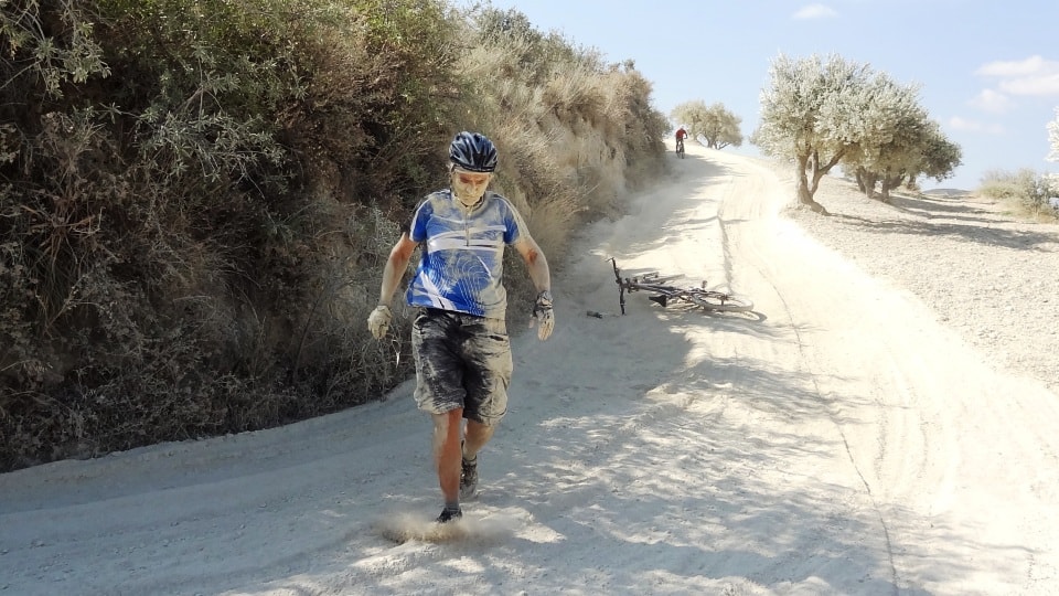 cyclist fall down in dust