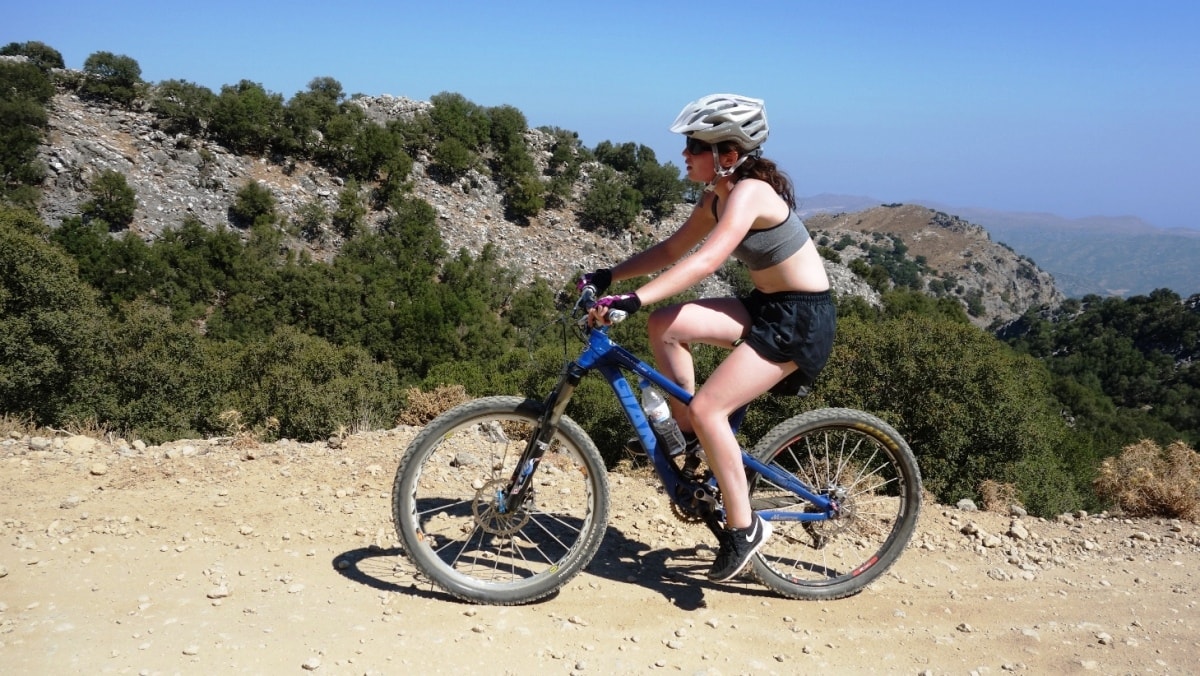 pretty lady cycling in crete greece